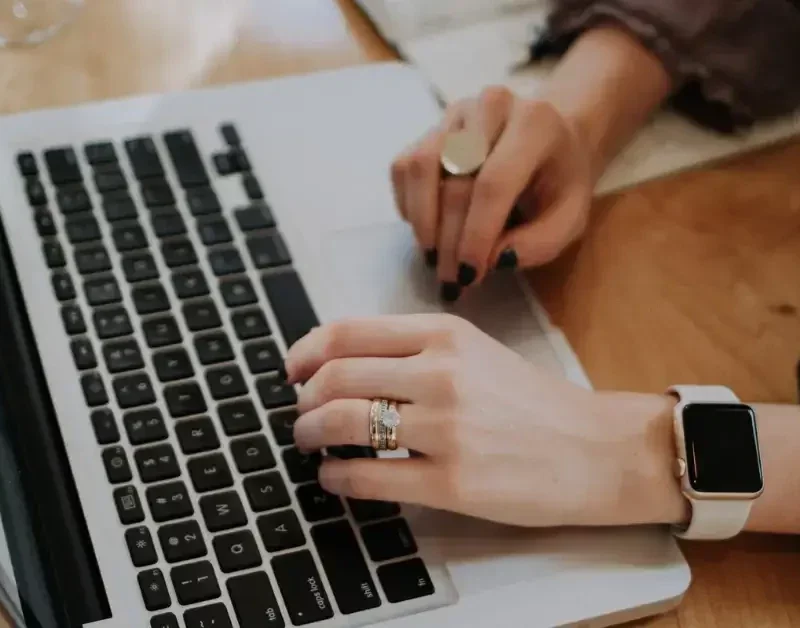 Woman researching investment property mortgage requirements on her computer.